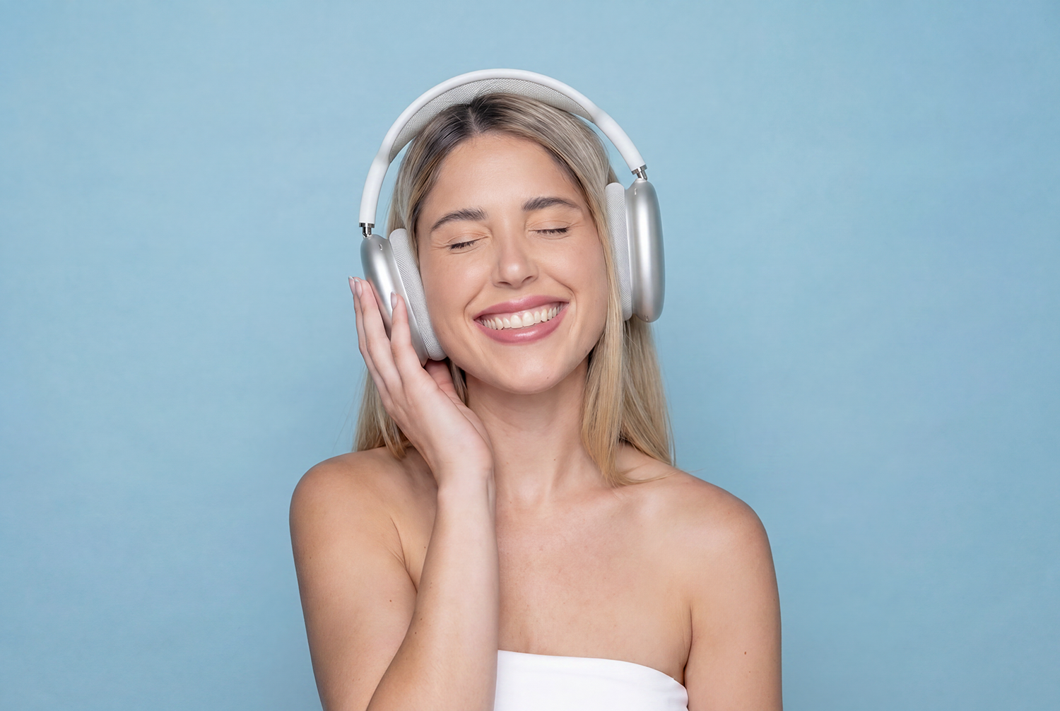 Woman smiling and enjoying relaxing spa music through headphones